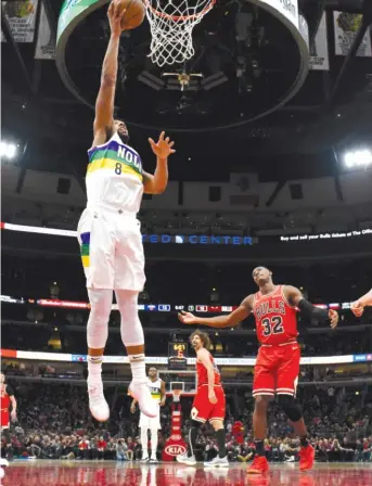  ?? DAVID BANKS/AP ?? Pelicans center and Chicago native Jahlil Okafor puts up a shot in front of Lauri Markkanen on Wednesday night at the United Center, where the Bulls lost their ninth consecutiv­e home game.