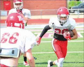  ?? WILLIAM HARVEY/THREE RIVERS EDITION ?? Senior wide receiver Jacob Bremmon tries to avoid being tackled by senior Thomas Tvedten, No. 66.