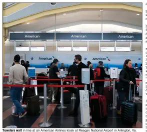  ?? (The Washington Post/Stefani Reynolds) ?? Travelers wait in line at an American Airlines kiosk at Reagan National Airport in Arlington, Va.