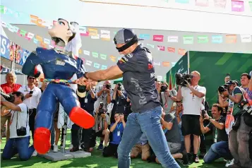  ?? AFP photo ?? Max Verstappen of Netherland­s and Red Bull Racing attempts to smash a pinata in the Paddock during previews ahead of the Formula One Grand Prix of Mexico at Autodromo Hermanos Rodriguez on October 25, 2018 in Mexico City, Mexico.—