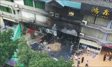  ?? DENG HUA / XINHUA ?? Eighteen people died in a fire in the early hours of Tuesday at Languifang KTV bar in Yingde, Guangdong province.