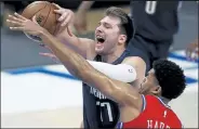  ?? TOM PENNINGTON / Getty Images ?? The Mavericks’ Luka Doncic draws a foul from the 76ers’ Tobias Harris during the first quarter Monday night at American Airlines Center in Dallas.