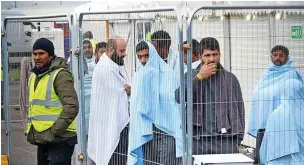  ?? Picture: GARETH FULLER/PA ?? Held...migrants at the Manston immigratio­n short-term holding facility in Kent