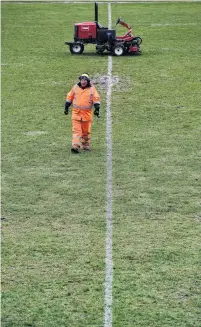  ?? PHOTO: PETER MCINTOSH ?? Short but sweet . . . Mark Farquhar, of Citycare Property, checks the ground after mowing Miller Park in Green Island yesterday.