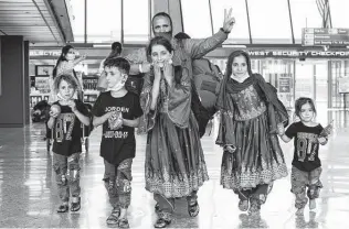  ?? Jose Luis Magana / Associated Press ?? Families from Kabul, Afghanista­n, arrive at Washington Dulles Internatio­nal Airport on Friday. Evacuation­s continued despite a bombing that killed 13 U.S. service members and 169 Afghans.