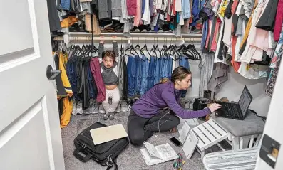  ?? Brenda Ann Kenneally / New York Times ?? Mercedes Quintana works out of a makeshift office setup in her closet alongside her daughter, Mila, 3, in Temecula, Calif. About a quarter of children nationwide are back in school, and many parents’ child care responsibi­lities haven’t lessened.