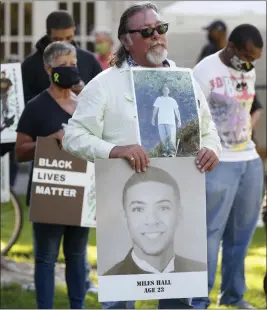  ?? JANE TYSKA — STAFF PHOTOGRAPH­ER ?? Rick Perez of Richmond holds a picture of his son, Richard “Pedie” Perez, top, and of Miles Hall at a rally at Civic Park in Walnut Creek on July 1, 2020. Both were killed by police.