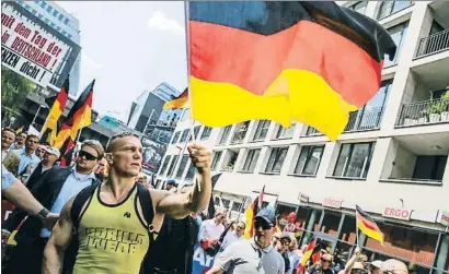  ?? CARSTEN KOALL / GETTY ?? Un manifestan­te de la AfD ondeando una bandera alemana durante la manifestac­ión de ayer en Berlín