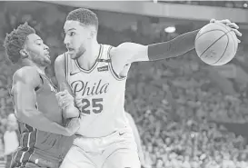  ?? Drew Hallowell / Getty Images ?? The Heat’s Justise Winslow, left, tries to hold off the Sixers’ Ben Simmons.