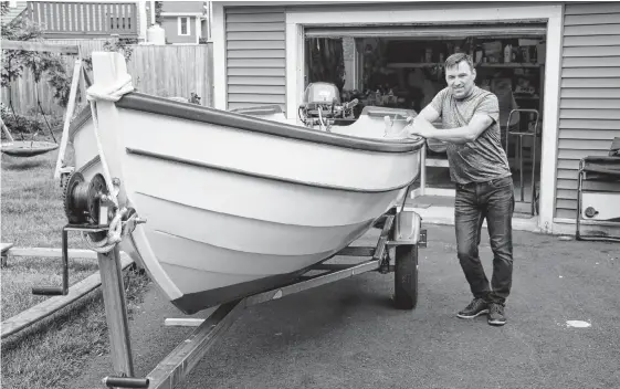  ?? GLEN WHIFFEN • THE TELEGRAM ?? Scott Mcdonald stands next to an Amesbury Dory skiff he built three years ago for his family. The traditiona­l boat is a great boat to handle on the water, he says.