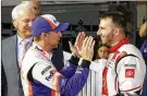  ??  ?? Denny Hamlin (left) talks with Matt DiBenedett­o after Saturday night’s race.