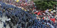  ?? PUNIT PARANJPE/AFP/GETTY IMAGES ?? Police block protesters at the APEC summit in the Philippine­s.