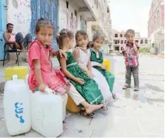  ??  ?? Displaced Yemeni children from Hodeida province sit on water containers in a street in the southweste­rn Yemeni city of Taez. — AFP