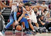  ?? [AP PHOTO] ?? Cleveland Cavaliers’ Collin Sexton (2) and Oklahoma City Thunder’s Steven Adams (12) battle for a loose ball during the Thunder’s 95-86 win Wednesday night in Cleveland. Adams scored nine points and had 13 rebounds in the game.