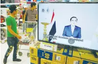  ?? (Jorge Silva/Reuters) ?? THAI PRIME Minister Prayuth Chan-ocha is seen delivering a broadcast message to the nation on a screen inside a shopping mall in Bangkok yesterday.