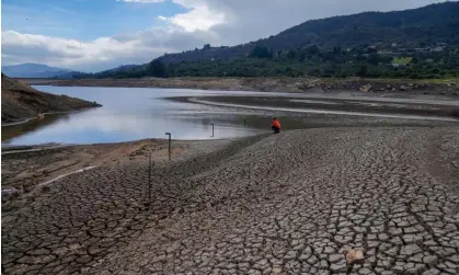  ?? Photograph: Fernando Vergara/AP ?? A worker monitors the water level of a reservoir in the outskirts of Bogotá on 8 April.