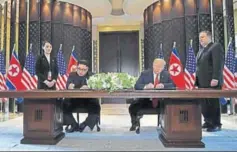  ?? AFP ?? Trump and Kim sign a document at the Capella Hotel on Sentosa island in Singapore.