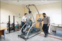  ?? REZVAN NASIRI VIA THE NEW YORK TIMES ?? The “exoskeleto­n” device created by Iranian researcher­s is tested on a treadmill. A kind of lightweigh­t harness, the device is worn around the midsection and legs, and can increase someone’s running efficiency by about 8 percent or more, according to a new study.