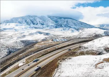  ?? Photograph­s by Myung J. Chun Los Angeles Times ?? SNOW covered hills Monday along the 5 Freeway in Gorman. Northern L.A. County mountains have seen up to 4 feet since Sunday.