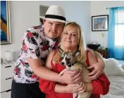  ?? PEDRO PORTAL pportal@herald.com ?? Tyler Borjas, 25, with his mother, Kelly Bain-Borjas, and his Chihuahua, Tito, at home on Aug. 22.
