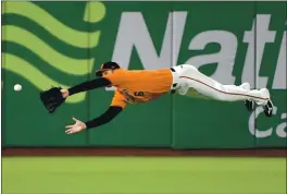  ?? DOUG DURAN — BAY AREA NEWS GROUP, FILE ?? Giants outfielder Steven Duggar makes a diving catch to rob Diamondbac­ks batter Robbie Ray of a hit during their May 2019 game in San Francisco.