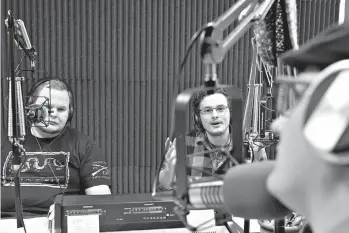  ?? James Durbin /Reporter-Telegram via AP ?? Guests Lewis Busbee, left, and Cory Maxwell, center, talk with station manager Chris Brown, right, during the “Eyes on Psych” radio show Dec. 8 at the Recording Library of West Texas in Midland Shared Spaces.
