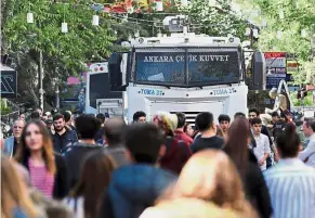  ??  ?? Crowd control: A Turkish riot police truck in Ankara parked near protesters during a demonstrat­ion against the arrests of Gulmen and Ozakca. — AFP