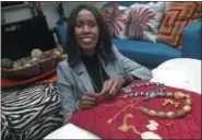  ?? JIM MONE - THE ASSOCIATED PRESS ?? Shamila Nduriri, who owns Dalasini, an upscale jewelry company, poses in her Minneapoli­s apartment with some of her jewelry. Nduriri, who studied finance in college, saved aggressive­ly when she worked for a corporatio­n and continues to put money aside now that she owns Dalasini.