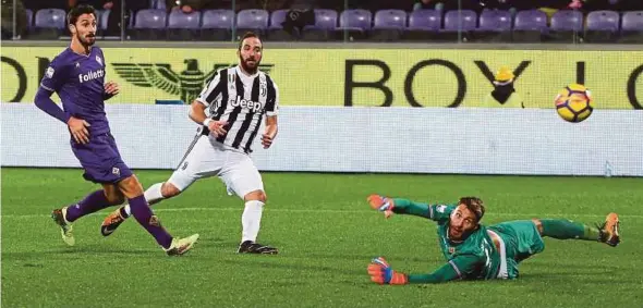  ?? REUTERS PIC ?? Gonzalo Higuain (centre) scores Juventus’ second goal against Fiorentina at the Atemio Franchi Stadium on Friday.