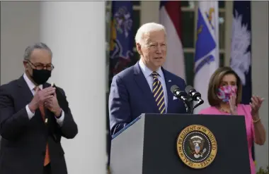  ?? ALEX BRANDON—ASSOCIATED PRESS ?? In this March 12, 2021, file photo President Joe Biden speaks about the American Rescue Plan, a coronaviru­s relief package, in the Rose Garden of the White House in Washington. Senate Majority Leader Chuck Schumer of N.Y., left, and House Speaker Nancy Pelosi of Calif., listen.