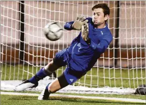  ?? Arnold Gold / Hearst Connecticu­t Media ?? Guilford goalie Justin Hess blocks a penalty shot in the second half of the SCC championsh­ip in Madison against Daniel Hand in 2020.