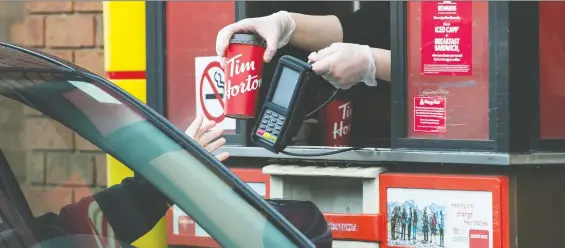  ?? NATHAN DENETTE/THE CANADIAN PRESS FILES ?? A class-action lawsuit filed in Quebec is challengin­g Tim Hortons over a perceived privacy breach from collecting data through its mobile app.