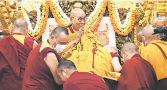  ?? — AFP file photos ?? Dalai Lama (centre) arrives to attend a long life prayer offered to him by his students and devotees at a temple in McLeod Ganj, some 10Km from Dharamsala on October 25, 2023.