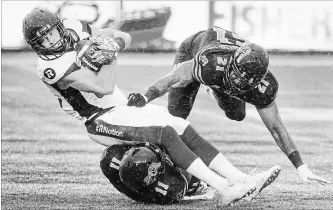  ?? SCOTT GARDNER THE HAMILTON SPECTATOR ?? Ottawa Redblacks wide receiver Greg Ellington is downed by Hamilton Tiger-Cats Larry Dean (11) and Simoni Lawrence during Canadian Football League action at Tim Hortons Field on Saturday afternoon.