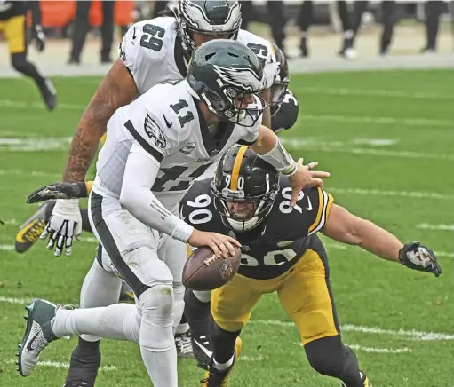  ?? Peter Diana/ Post- Gazette ?? T. J. Watt closes in on one of the Steelers’ five sacks of Eagles quarterbac­k Carson Wentz in Sunday’s 38- 29 win at Heinz Field.