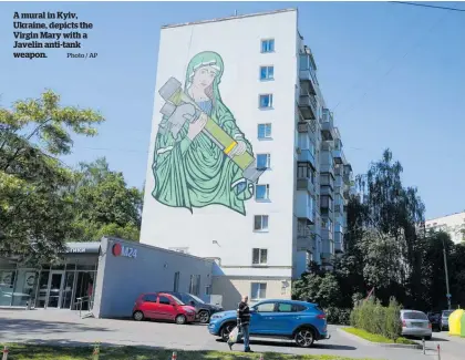  ?? Photo / AP ?? A mural in Kyiv, Ukraine, depicts the Virgin Mary with a Javelin anti-tank weapon.
