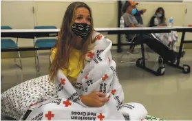  ?? Gabrielle Lurie / The Chronicle ?? Evacuee Shawnee Whaley, 57, who believes her house burned down, sits in the Red Cross shelter at the Ulatis Cultural Center in Vacaville.