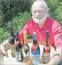  ?? STEVE SHARRATT/THE GUARDIAN ?? P.E.I. winemaker John Rossignol with his medal winners at the Little Sands winery.