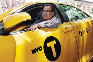  ??  ?? NEW YORK: In this photo, taxi driver and taxi medallion owner Marcelino Hervias poses for photos with his taxicab on New York’s Upper West Side. —AP photos