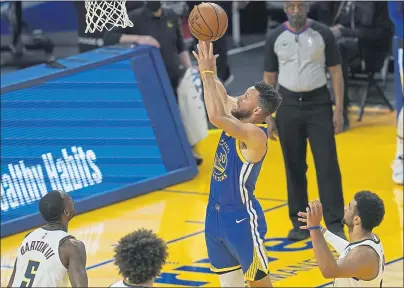  ?? PHOTOS BY JEFF CHIU — THE ASSOCIATED PRESS ?? Warriors guard Stephen Curry (30) shoots against the Denver Nuggets during a game in San Francisco on Monday night.