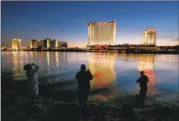  ?? Luis Sinco Los Angeles Times ?? FISHERMEN CAST their lines into the Colorado River near Laughlin, Nev., a casino town with a population of about 9,000, in May 2022.