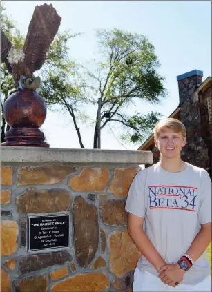  ?? TAMMY KEITH/RIVER VALLEY & OZARK EDITION ?? Drake Toll, who will be a Vilonia High School senior this fall, stands by an eagle statue on campus, a project he spearheade­d with other students. Toll, 17, was elected state Beta Club president in January and national Beta Club president in June. He was in Washington, D.C., last week and will travel during the 2018-19 school year to state convention­s to give keynote speeches and network. He will also preside over the June 2019 national convention in Oklahoma City.