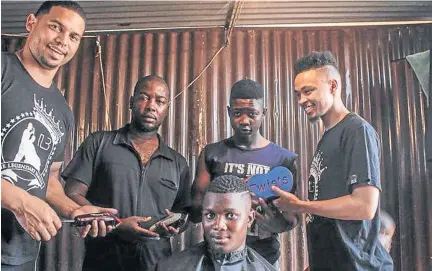  ??  ?? Sheldon Tatchell, left, has opened training centres to upskill youth who are passionate about haircuts.