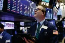  ?? RICHARD DREW — THE ASSOCIATED PRESS ?? Trader William Lawrence works on the floor of the New York Stock Exchange, Wednesday.