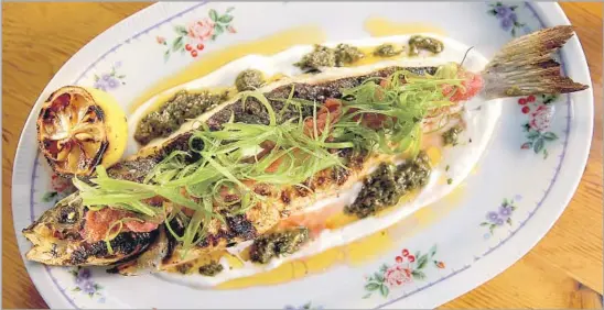  ?? Photograph­s by Kirk McKoy Los Angeles Times ?? THE DAILY CATCH at the Exchange, an Israeli-leaning restaurant downtown, pairs a grilled fish with black olive and seaweed chermoula, fennel pollen and citrus.