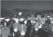  ?? COURTESY ERIC BEAUBIEN PHOTOGRAPH­Y ?? Walkers hold lanterns at a past Silicon Valley Light the Night Walk.