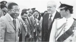  ??  ?? Robert Mugabe, left, meets with Prince Charles, right, on April 16, 1980. The next day, Mugabe became leader of newly independen­t Zimbabwe.