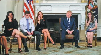  ?? JONATHAN ERNST / REUTERS ?? Marjory Stoneman Douglas High School shooting survivors Jonathan Blank (2nd left) and Julia Cordover (3rd left) as well as Jonathan’s mother Melissa Blank (left) and fellow student Carson Abt (right) listen along with US President Donald Trump to...