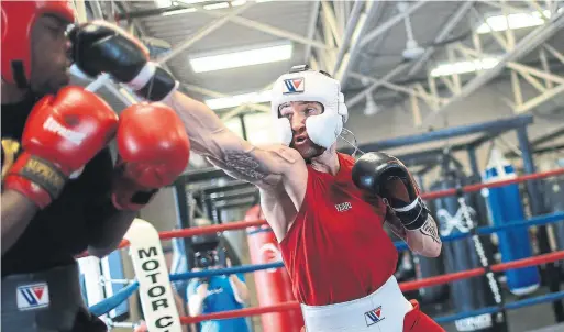  ??  ?? Canadian super-welterweig­ht champ Cody Crowley, connecting with a right while sparring with Michael Brandon, hopes to expand his boxing promotion company.