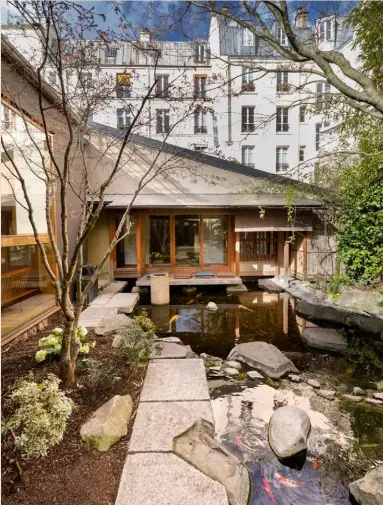  ??  ?? Exterior Nestled amid more traditiona­lly Parisian properties, this home is at once discreet and completely different Opposite, top EOOS’s ‘Living Landscape 755’ sofa for Walter Knoll creates
a relaxing spot in this open-plan space. For a similar high table and chairs, try Shang Xia. The ‘Butterfly’ stool is by Sori Yanagi for Vitra Opposite, bottom By the floating oak staircase, which links the living room with the dining room on the next level, a custom-made bench and coffee table by Kengo Kuma & Associates is paired with two ‘Clio’ armchairs by Antonio Citterio for
Maxalto at B&B Italia. The armchair is the ‘Le Chat’ by Pierre Paulin for Artifort